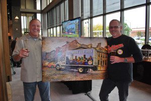 Joe and Dominick holding Baltimore Beer Week Art